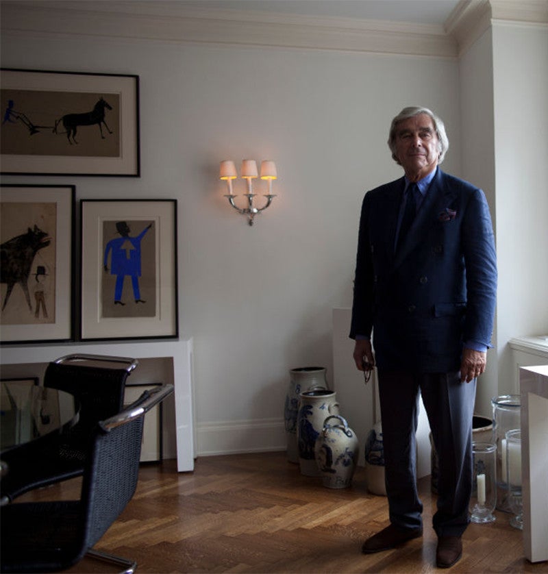 Jerry Lauren in his Manhattan apartment with a selection of Traylor&rsquo;s works on the wall behind him