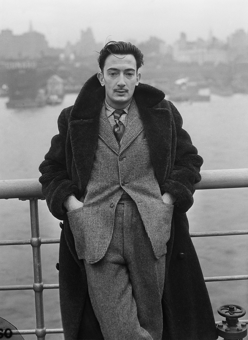 Salvador Dalí in a statement coat on the deck of the <em>S.S. Normandie</em>