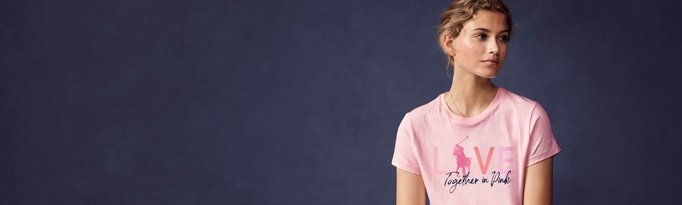 Woman in light pink "Live Love" Pink Pony graphic tee